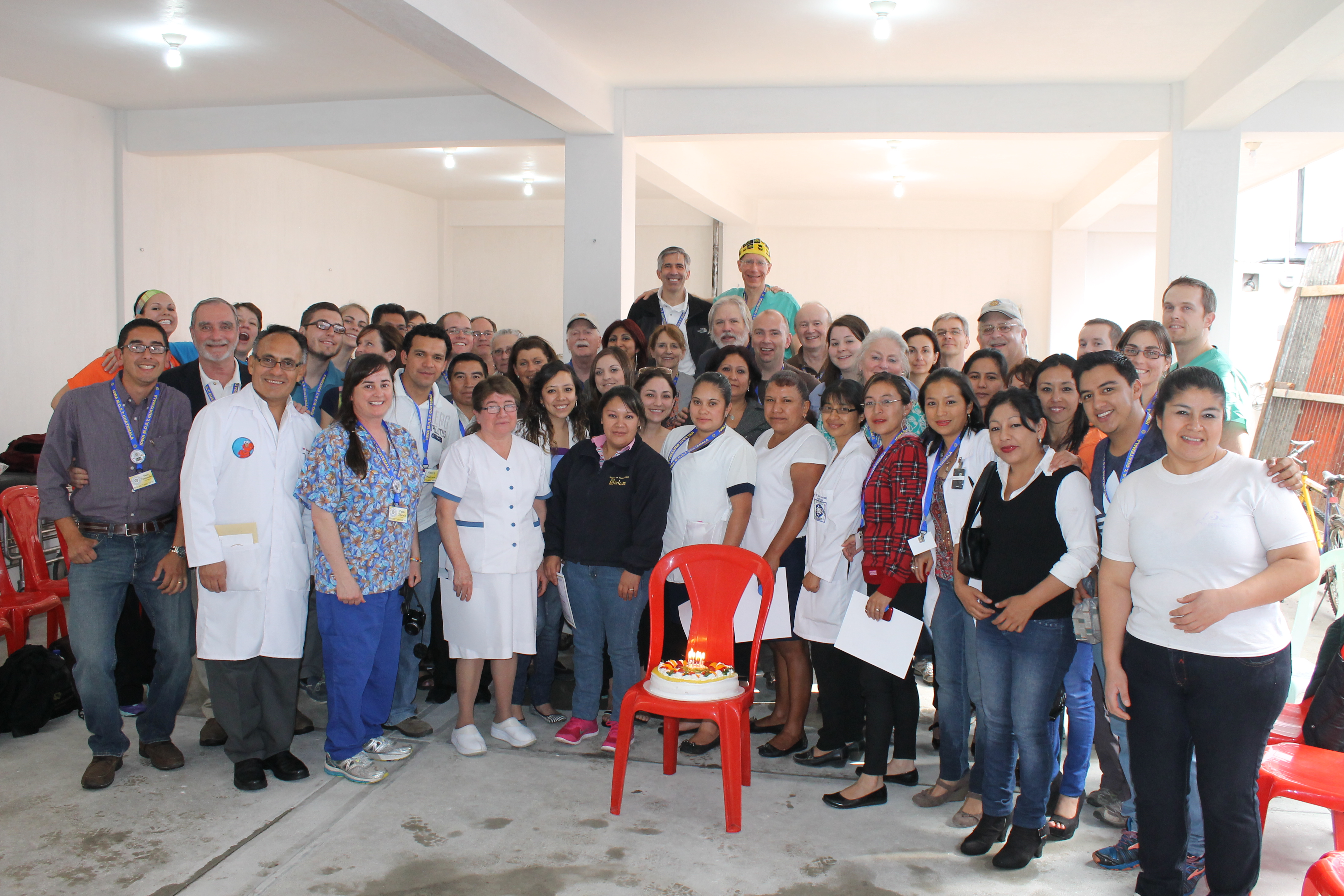 Staff at Hospital Salus with a cake celebrating our 10 year anniversary.